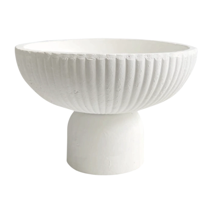 A white textured ceramic serving bowl on a pedestal base for catering.
