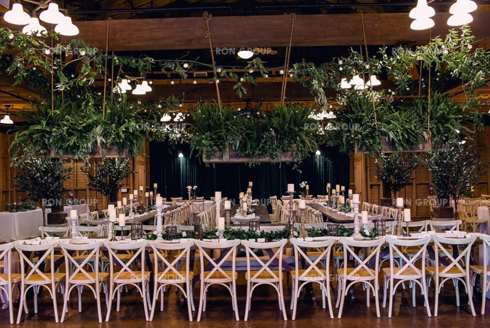Rows of Cross Back Chairs set up for a large indoor ceremony