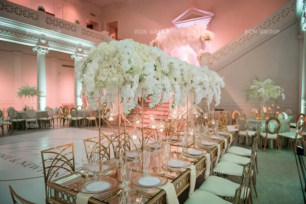 Grand wedding reception with mirrored tables and gold chairs