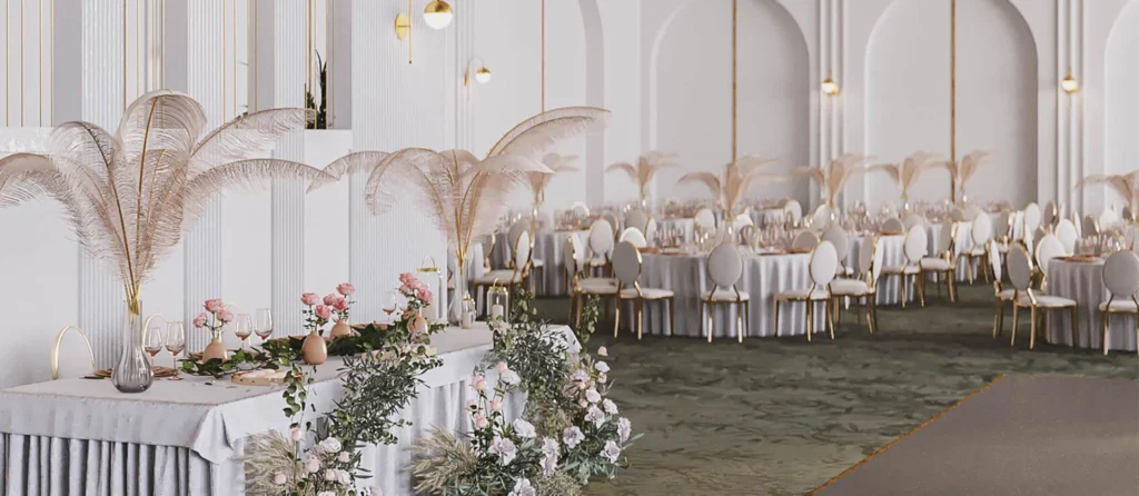Luxurious white indoor wedding reception with white round-back upholstered chairs, feather centerpieces and crystal chandeliers.