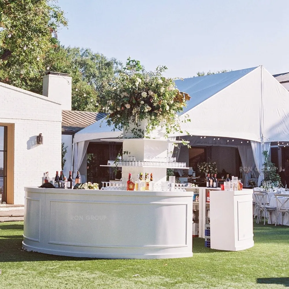 Luxury white circular bar set up on green lawn for outdoor wedding