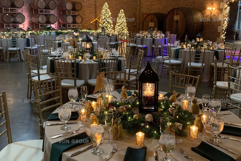Gold Chiavari chairs set up in a rustic barrel room for a holiday event