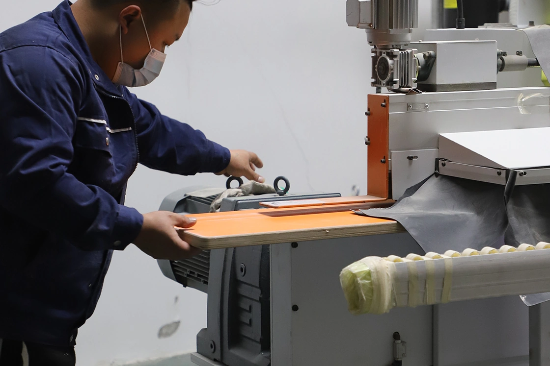 Technician operating precision woodworking machinery on a production line.